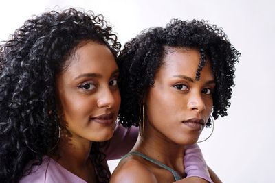 Portrait of two women of color hugging each other