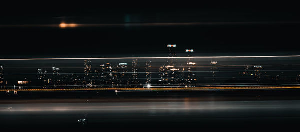 Light trails on road in city at night