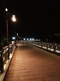 Illuminated bridge at night