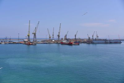 Sailboats in sea against sky