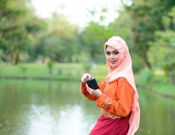 Portrait of a young woman holding leaf