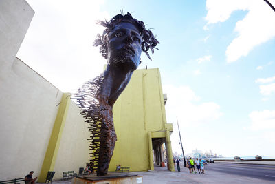 Low angle view of statue against sky in city