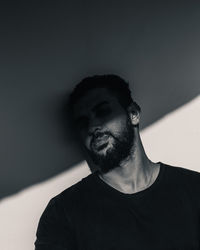 Portrait of man standing against wall