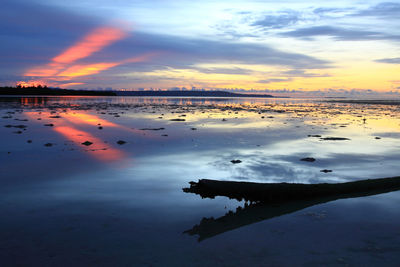 Scenic view of beach against sky during sunset