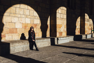 Woman sitting on seat at avila