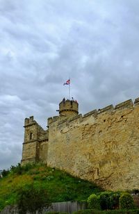 Low angle view of building against cloudy sky