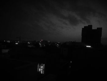 View of illuminated cityscape against sky at night