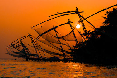 Silhouette of fishing nets at sunset