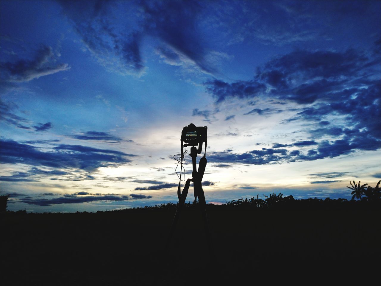 LOW ANGLE VIEW OF SILHOUETTE TELEPHONE POLE ON FIELD AGAINST SKY