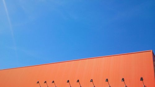 High section of building against blue sky