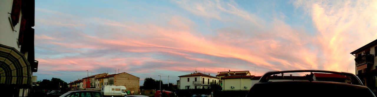 sunset, architecture, building exterior, sky, built structure, car, land vehicle, transportation, orange color, cloud - sky, mode of transport, cloud, city, residential structure, residential building, house, cloudy, street, outdoors, building