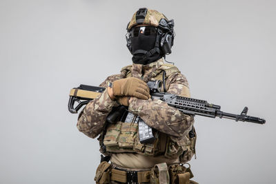 Rear view of soldiers standing against white background