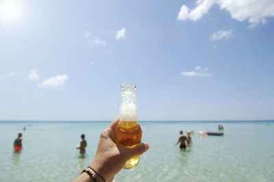 People on beach against sky