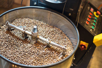 Coffee beans roasting in machine.