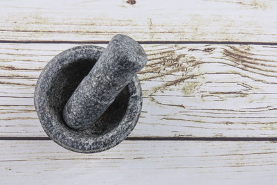 High angle view of mortar and pestle on table