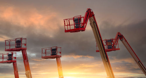 Articulated boom lift. aerial platform lift. telescopic boom lift with sunset sky. mobile crane.