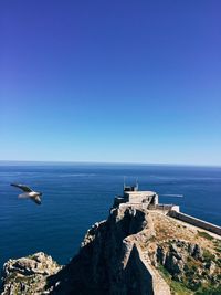 Scenic view of sea against clear blue sky