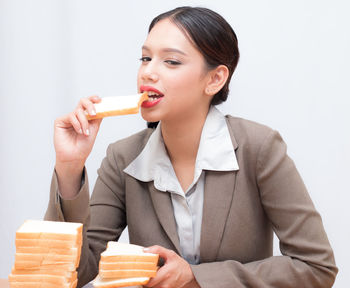 Portrait of young woman eating food