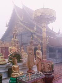 Statue of temple against building