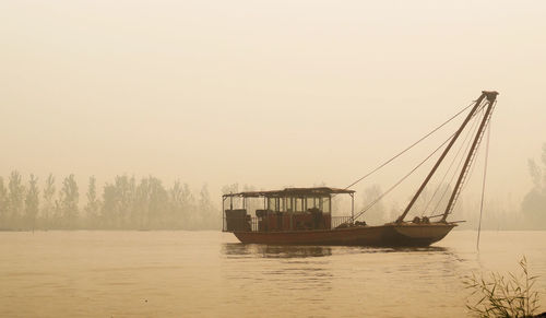 Boat in river during foggy weather