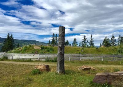 Scenic view of field against cloudy sky