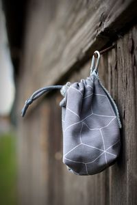 Close-up of leaf hanging on wood against wall