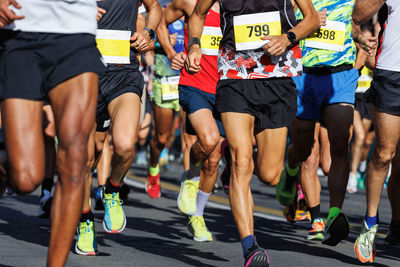 International marathon running race, people feet on city road