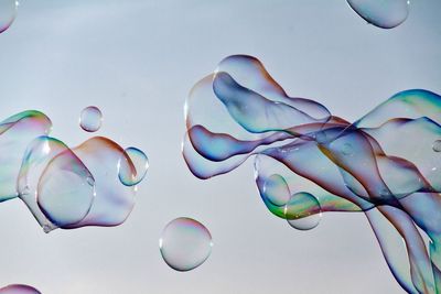 Close-up of bubbles against blue sky