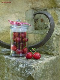 Close-up of cherries in glass jar