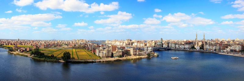 High angle view of river and cityscape against sky