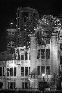 Illuminated buildings against sky at night