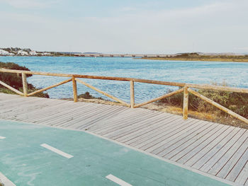 View of swimming pool by sea against sky