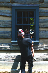 Full length of boy standing against window