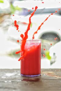 Close-up of red drink on table