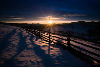 Scenic view of snowcapped mountains against sky during sunset