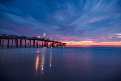 View of bridge over sea at sunset
