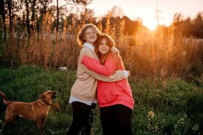 Full length of woman with dogs on field