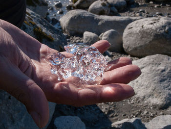 Close-up of human hand holding rock