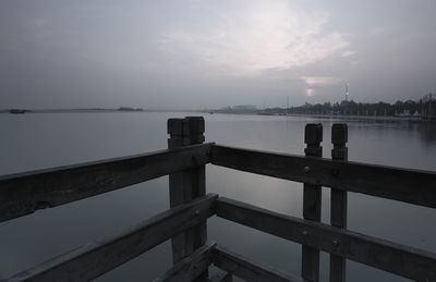Pier over lake against sky