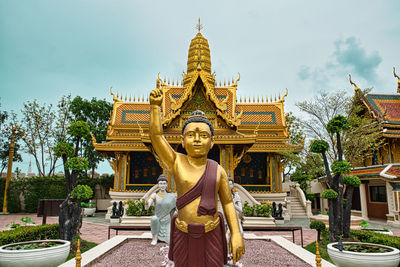 Statue of temple against building