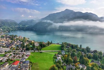 High angle view of lake and mountains against sky