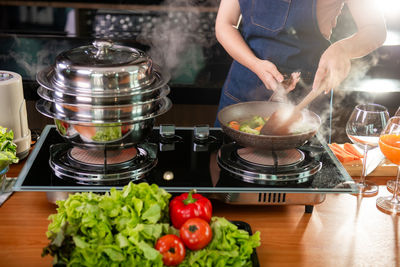 Midsection of woman preparing food on table