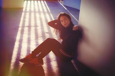 Portrait of young woman sitting outdoors