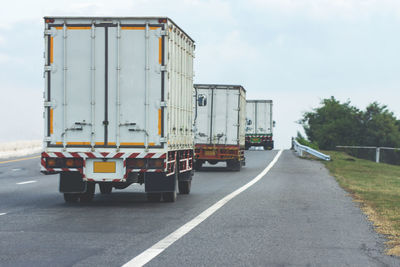 Vehicles on road against sky