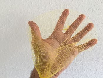 Close-up of hand on wall