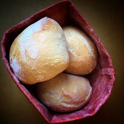 Directly above shot of breads in paper bag on table