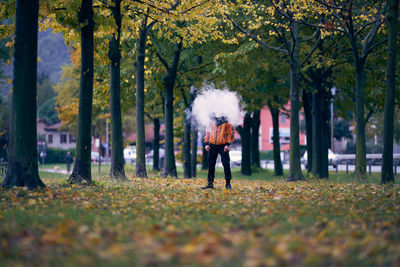 Full length of man standing by tree during autumn