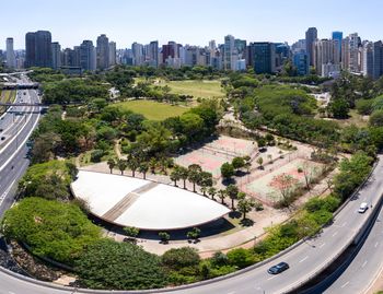 High angle view of trees and buildings in city