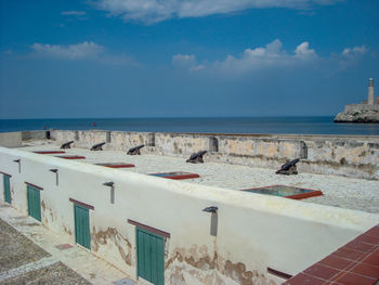 View of swimming pool by sea against sky