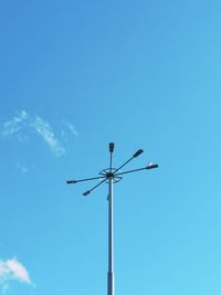 Low angle view of street light against blue sky